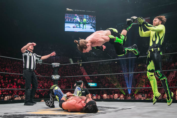 South African luchador Angélico (standing) and his American tag team partner Jack Evans.